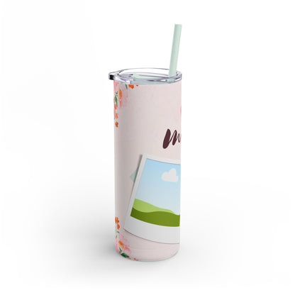 A set of three stainless steel tumblers with reusable straws and clear lids. The design features a soft pink background adorned with delicate floral accents in shades of pink and orange. The center tumbler displays the word "mom" in elegant script with a heart above it. Each tumbler includes placeholders for family photos, framed against a scenic backdrop of green hills, blue skies, and white clouds, creating a heartfelt and personalized theme perfect for moms.