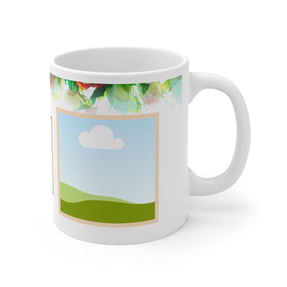A white ceramic mug featuring a colorful floral design at the top, with vibrant pink, green, and orange flowers. The design includes a placeholder photo frame with a scenic illustration of green hills under a blue sky with a white cloud, bordered in soft peach. The floral elements give the mug a fresh, lively, and personalized touch, ideal for showcasing a favorite photo.