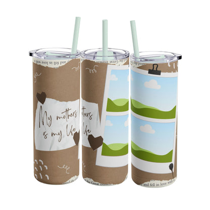 A set of three stainless steel tumblers with reusable straws and clear lids. The design features a warm, earthy brown background with artistic elements like torn paper textures and doodles. One tumbler displays the heartfelt phrase "My mother is my life" in elegant handwritten script, while the other two include placeholders for family photos framed against a scenic backdrop of green hills, blue skies, and fluffy white clouds. The overall design combines rustic charm with personalization, celebrating the bo