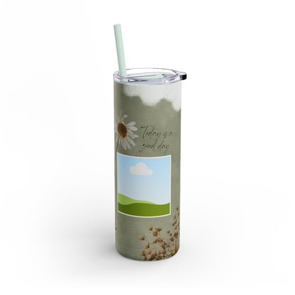 A set of three stainless steel tumblers with reusable straws and clear lids. The design features an earthy green background accented with subtle white paintbrush strokes. Each tumbler includes placeholders for scenic photos with green hills and blue skies. Hand-drawn wildflowers, daisies, and delicate ferns add a natural, rustic charm, while one tumbler features the uplifting phrase "Today is a good day" in elegant script. The design evokes a serene, nature-inspired theme perfect for personalization.